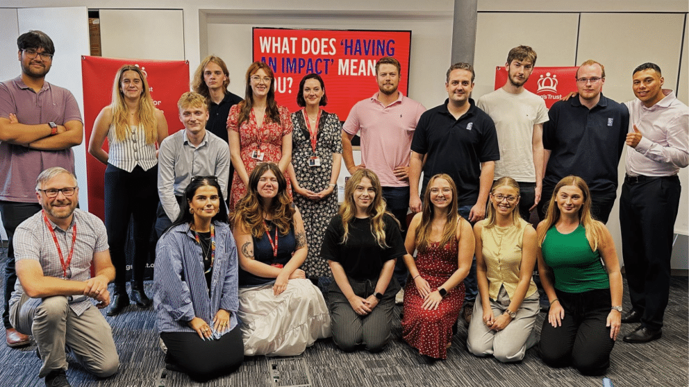 Group of people stood in front of The King's Trust banners